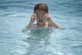 Girl adjusting goggle in pool
