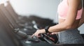 Girl adjusting speed on treadmill, doing cardio workout