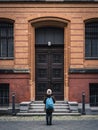 A girl admiring a huge door in Berlin