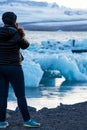 Girl admiring the scenery with ice depths in the famous Jokulsarlon glacial lagoon in Iceland. Exotic countries. Amazing places. Royalty Free Stock Photo