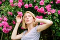 Girl adorable blonde sniffing fragrance of pink bloom. Spring and summer. Perfume and cosmetics. Woman in front of Royalty Free Stock Photo