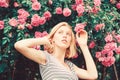 Girl adorable blonde sniffing fragrance of pink bloom. Spring and summer. Perfume and cosmetics. Woman in front of