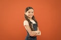 Girl adorable kid stand over orange background. What is key to childhood happiness. Happy childhood. Grow mentally and