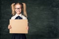 Girl Advertising Poster in School Classroom, Pupil Child in Glasses Hold Blank Board Advertisement Royalty Free Stock Photo