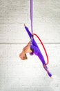 Girl aerial gymnast on a circle doing acrobatic elements