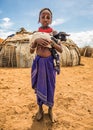 Girl from the African tribe Dasanesh holding a goat