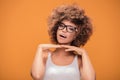 Girl with afro hairstyle wearing fashionable eyeglasses. Royalty Free Stock Photo