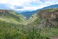 A girl against the background of the Khunzakh valley, Khunzakh waterfalls, a canyon in Dagestan 2021