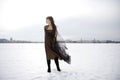 Girl against a background of snow and the city.