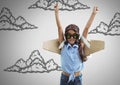 Girl against grey background with cardboard pilot wings and cloud illustrations