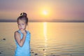 Girl against a pink sunset over salt lake Royalty Free Stock Photo