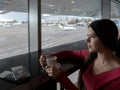 Girl in airport`s business lounge with cup of coffee Royalty Free Stock Photo