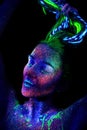 The girl  aliens asleep. Hands near the face, ultraviolet make-up. Raises her hair Royalty Free Stock Photo