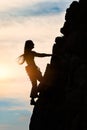 Girl alone during a climb in a fantastic mountain landscape at s