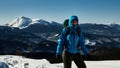 Girl alone travels the winter mountains with a backpack Royalty Free Stock Photo