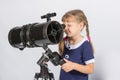 Girl amateur astronomer sets up a telescope for observing the starry sky