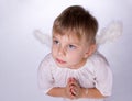 Girl with angel wings praying