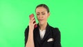 Girl angrily speaks on the phone, proves something. Green screen