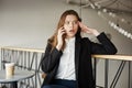 Girl is angry and shocked. Portrait of stunned irritated businesswoman sitting in cafe, leaning on handrail, looking