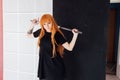 Girl sword Japan cosplayer anime red hair Royalty Free Stock Photo