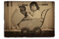 Girl in antique baby carriage