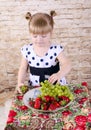 Girl with an appetite for eating fresh strawberries