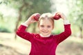 Girl with Apple holding in front of her face in Orchard. Harvest Concept Royalty Free Stock Photo