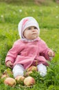 Girl and apples on a grass