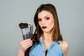 Girl apply eye shadows. Woman applying makeup brush. Emphasize femininity. Professional makeup supplies. Skin care