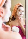 Girl applying cream on skin Royalty Free Stock Photo