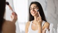 Girl Applying Face Powder Using Makeup Brush Standing In Bathroom Royalty Free Stock Photo