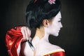 Girl applying geisha makeup