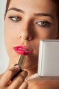 Girl Applying Lipstick Royalty Free Stock Photo