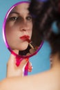 Girl applying make up red lipstick Royalty Free Stock Photo