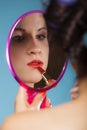 Girl applying make up red lipstick Royalty Free Stock Photo