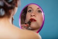 Girl applying make up red lipstick Royalty Free Stock Photo