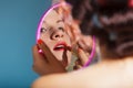 Girl applying make up red lipstick Royalty Free Stock Photo