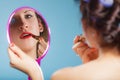 Girl applying make up red lipstick Royalty Free Stock Photo