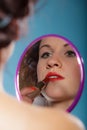 Girl applying make up red lipstick Royalty Free Stock Photo