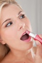 Girl applying pink lip stick