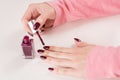 Elegant Manicure: Applying Red Wine Nail Polish with Precision Royalty Free Stock Photo