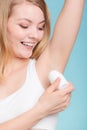 Girl applying stick deodorant in armpit. Royalty Free Stock Photo