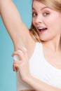 Girl applying stick deodorant in armpit. Royalty Free Stock Photo