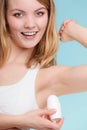 Girl applying stick deodorant in armpit. Royalty Free Stock Photo