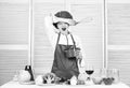 Girl in apron whipping eggs or cream. Start slowly whisking or beating cream. Confectionery and patisserie. Whipping