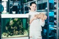 Girl in aquarium store holding big sandstone