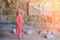 Girl among the archaeological excavations in the dungeon Anthony terms, an ancient Roman building. Ruins of antique inscriptions