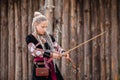girl archer aims and shoots from a short bow Royalty Free Stock Photo