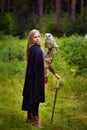 Girl in armor and with a sword holding an owl