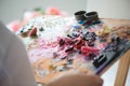 girl artist mixes oil paints on a palette. Royalty Free Stock Photo